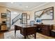 A stately home office with wooden desk, detailed trim and millwork, and neutral paint at 2500 S Clayton St, Denver, CO 80210