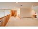 Spacious bonus room with wood railing and recessed lights, providing a flexible living space for various activities at 101 Glenmoor Ln, Cherry Hills Village, CO 80113
