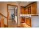 Hallway wet bar has custom cabinetry and lighting at 101 Glenmoor Ln, Cherry Hills Village, CO 80113
