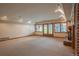 Large, carpeted basement with recessed lighting and windows, providing ample natural light, in this beautifully staged home at 101 Glenmoor Ln, Cherry Hills Village, CO 80113