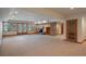 Spacious finished basement featuring a brick fireplace, neutral carpet, and double doors leading to the outside at 101 Glenmoor Ln, Cherry Hills Village, CO 80113
