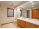 Bright bathroom with beautiful vanity, large mirror, tile floors, and natural light from two windows at 101 Glenmoor Ln, Cherry Hills Village, CO 80113