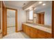 Bathroom featuring a granite countertop, wooden cabinets, and tiled flooring at 101 Glenmoor Ln, Cherry Hills Village, CO 80113