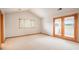 Bright bedroom featuring carpet flooring, window and door to balcony allowing natural light to enter at 101 Glenmoor Ln, Cherry Hills Village, CO 80113