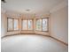 Large bonus room with bright windows, plush carpeting, and neutral paint at 101 Glenmoor Ln, Cherry Hills Village, CO 80113