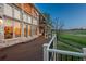 Large wooden deck overlooking a lush green landscape and mature trees, perfect for outdoor relaxation and entertainment at 101 Glenmoor Ln, Cherry Hills Village, CO 80113