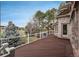 Spacious wooden deck with white railings, offering views of a well-manicured yard and mature trees at 101 Glenmoor Ln, Cherry Hills Village, CO 80113
