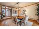 Well-lit dining room with hardwood floors and light-colored walls featuring a modern light fixture and table setting at 101 Glenmoor Ln, Cherry Hills Village, CO 80113