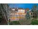 Rear exterior featuring a two-story brick home with a deck and a well-manicured lawn at 101 Glenmoor Ln, Cherry Hills Village, CO 80113