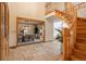 Inviting foyer with tile flooring, a curved staircase, and an open view to the dining and living areas at 101 Glenmoor Ln, Cherry Hills Village, CO 80113