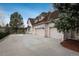 Spacious three car garage with driveway surrounded by well maintained landscaping at 101 Glenmoor Ln, Cherry Hills Village, CO 80113