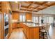 Gourmet kitchen featuring a stone-topped island, stainless steel appliances, and an adjacent dining area at 101 Glenmoor Ln, Cherry Hills Village, CO 80113