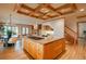 Open-concept kitchen with island stovetop and eat-in dining area adjacent to a cozy living room at 101 Glenmoor Ln, Cherry Hills Village, CO 80113