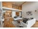 Bright living room with hardwood floors and neutral colored furniture, with a view to second-floor landing at 101 Glenmoor Ln, Cherry Hills Village, CO 80113