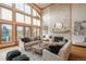 Comfortable living room featuring hardwood floors, a stone fireplace, high ceilings and natural light at 101 Glenmoor Ln, Cherry Hills Village, CO 80113