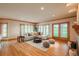 Bright living room boasts hardwood floors, fireplace, large windows, and a comfortable sectional couch at 101 Glenmoor Ln, Cherry Hills Village, CO 80113