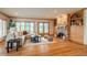 Sunlit living room featuring hardwood floors, a fireplace, built-in shelving, and large windows with outdoor views at 101 Glenmoor Ln, Cherry Hills Village, CO 80113