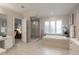 Bright bathroom featuring a glass shower, soaking tub, and modern vanity at 101 Glenmoor Ln, Cherry Hills Village, CO 80113