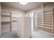 Well-organized walk-in closet with shelving and ample storage space and natural light at 101 Glenmoor Ln, Cherry Hills Village, CO 80113
