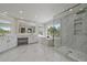 Spacious bathroom with marble flooring, standalone tub, glass shower, and scenic views at 1366 Killington Ct, Evergreen, CO 80439