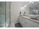 Modern bathroom features a glass-enclosed shower, dual sinks, and clean, contemporary design at 1366 Killington Ct, Evergreen, CO 80439