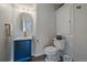 Modern bathroom with blue vanity, gold fixtures, and beautiful lighting at 1366 Killington Ct, Evergreen, CO 80439