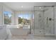 Bright bathroom with large window, soaking tub and marble walk in shower at 1366 Killington Ct, Evergreen, CO 80439