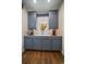Butler's pantry with grey cabinets, stone countertops and backsplash, and stainless appliances at 1366 Killington Ct, Evergreen, CO 80439