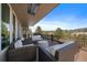 Comfortable outdoor seating area on deck with wicker furniture and scenic views of the surrounding landscape at 1366 Killington Ct, Evergreen, CO 80439