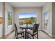 Bright dining area has amazing views from large windows that surround the room with a round table at 1366 Killington Ct, Evergreen, CO 80439