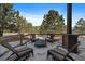 Outdoor firepit with four chairs around, ideal for cozy gatherings in a snowy setting at 1366 Killington Ct, Evergreen, CO 80439