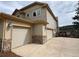 Attached three car garage featuring neutral siding and stone accents and large concrete driveway at 1366 Killington Ct, Evergreen, CO 80439