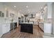 Modern kitchen featuring white cabinetry, a central island, and stainless steel appliances at 1366 Killington Ct, Evergreen, CO 80439