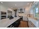 Bright kitchen features white cabinetry, stainless steel appliances, and a beautiful marble island at 1366 Killington Ct, Evergreen, CO 80439