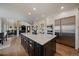 Open kitchen with modern appliances, custom cabinets, and an island great for entertaining at 1366 Killington Ct, Evergreen, CO 80439