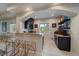 This modern kitchenette features barstool seating and a picturesque window to see the outdoors at 1366 Killington Ct, Evergreen, CO 80439
