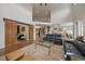 Open-concept living room with a barn door, high ceilings, and stylish decor at 1366 Killington Ct, Evergreen, CO 80439