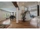 Spacious living room with hardwood floors, grand piano, staircase, and open floor plan at 1366 Killington Ct, Evergreen, CO 80439