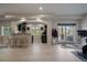 Open living room with kitchen view offers natural light, modern finishes and access to outdoor patio at 1366 Killington Ct, Evergreen, CO 80439