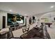 This theater room includes a large screen, a comfortable couch, and open concept access to other parts of the basement at 1366 Killington Ct, Evergreen, CO 80439