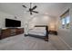 Spacious main bedroom features a large bed, contemporary furnishings, and lots of natural light at 1366 Killington Ct, Evergreen, CO 80439