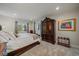 This main bedroom features bright lighting, a king bed, and two large windows at 1366 Killington Ct, Evergreen, CO 80439