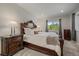 Comfortable main bedroom showcasing a decorative headboard, side tables and lots of natural light at 1366 Killington Ct, Evergreen, CO 80439