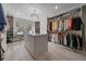Spacious walk-in closet with custom shelving, storage island, and organized shoe display at 1366 Killington Ct, Evergreen, CO 80439