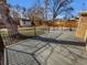 Large backyard deck with black railing, a shed and a wood fence, perfect for outdoor entertaining at 1479 S Bellaire St, Denver, CO 80222