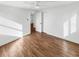 Bedroom with hardwood floors, white walls, ceiling fan, and ample natural light at 1479 S Bellaire St, Denver, CO 80222