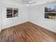 Bright bedroom with hardwood floors, white walls, and large windows for natural light at 1479 S Bellaire St, Denver, CO 80222