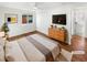 Bright bedroom features a ceiling fan, wood floors, and a walk in closet with an ensuite bathroom at 1479 S Bellaire St, Denver, CO 80222
