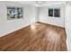 Bedroom with hardwood floors, white walls, and ample natural light from two windows at 1479 S Bellaire St, Denver, CO 80222