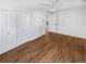 Spacious bedroom featuring hardwood floors, white walls, and ample closet space at 1479 S Bellaire St, Denver, CO 80222